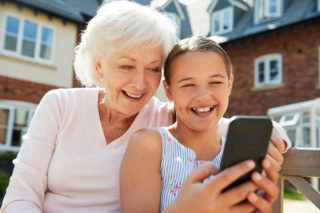 Woman and granddaughter on cell phone